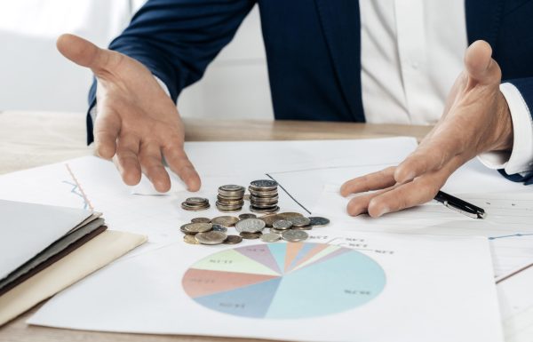 close-up-man-with-coins-statistics