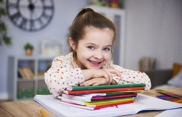 Smiling girl studying at home